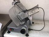an image of a meat slicer sitting on top of a counter