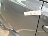 a sticker on the door of a car that is parked in a parking lot