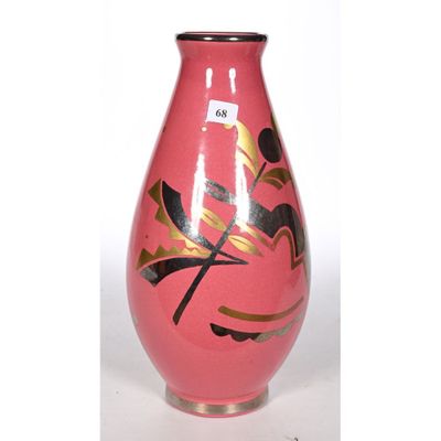 a pink vase with gold and black designs on it