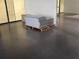 a large room with a couch and a pallet in it