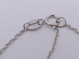 a close up of a silver chain with two rings on it