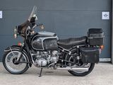 a black motorcycle parked in front of a garage door