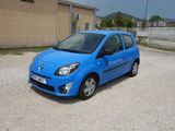 a small blue car parked in a parking lot