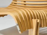 wooden slat lounge chair on a white surface with a white background