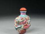 a small glass vase with a colorful design on it