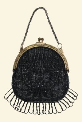 black beaded purse with gold trim and fringes