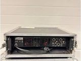 a black and silver case sitting on top of a black and white amplifier