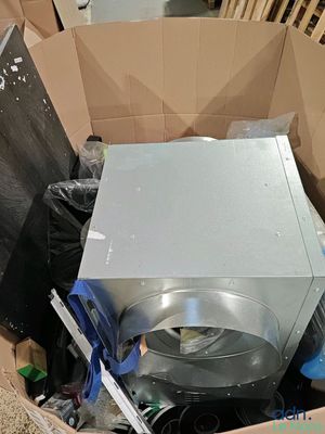 a cardboard box with a microwave inside of it