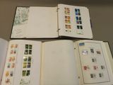 three open books with stamps on them sitting on a table