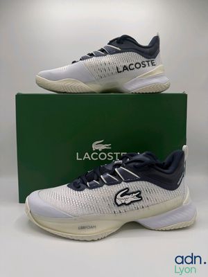 a pair of lacoste tennis shoes in a box