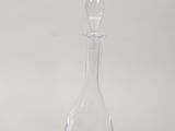 clear glass decanter on a white surface with a white background