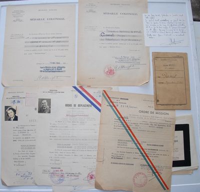 several old papers are piled on top of each other on a table