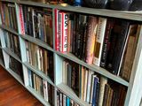 a book shelf with many books on top of it