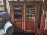 a blue couch in a living room with a bookcase