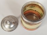a small cup with a lid sitting on a table