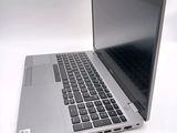 a silver laptop with a black keyboard on a white surface