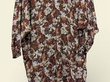 an image of a brown and white floral shirt hanging on a hanger