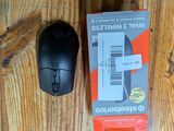 a black computer mouse and a red box on a wooden table