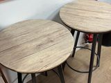 two tables that are sitting next to each other on the floor