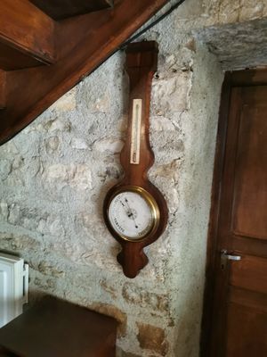 a clock hanging on the wall next to a radiator