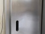 a stainless steel refrigerator in a kitchen with tile flooring