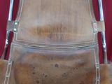 brown leather chair with metal frame and arm rest