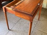a small wooden table with a drawer on it