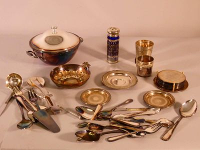 a lot of silverware on a table with a white background