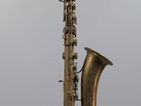 a saxophone hanging from the side of a pole