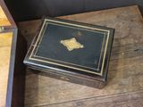 a small box sitting on a wooden table next to a mirror