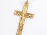gold plated crucift with jesus on the cross on a white background