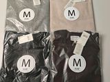 three t - shirts with the letter m on them are sitting on a table