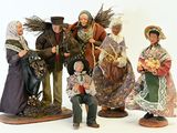 five figurines of people dressed in traditional clothing