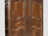 an image of a wooden cabinet with ornate carvings on the doors