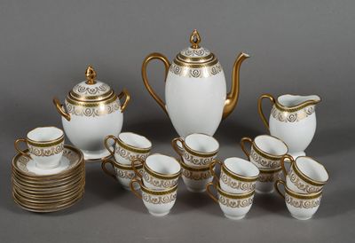 a white and gold tea set with cups and saucers