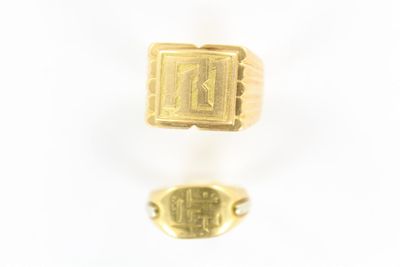 two gold rings with a signet in the middle and a small signet in the middle