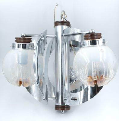 a chandelier with three glass globes hanging from the ceiling