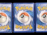 three plastic pokemon toys are sitting on a black surface