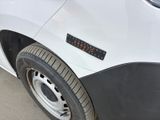 a close up of a white truck with a sticker on it ' s side