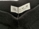 the back of a pair of black pants with a label on it
