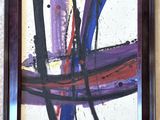 abstract painting on a wall with a brown frame and a white wall