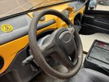 a steering wheel and dashboard of a small vehicle