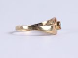 an image of a close up of a gold ring on a white surface