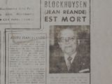 newspaper article with a picture of a man in a suit and tie