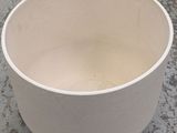 a white bowl sitting on the floor on the floor