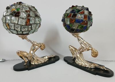 two sculptures of a man holding a ball on top of each other