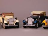 several toy cars are lined up in a row on a gray surface