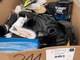 a cardboard box with a helmet, gloves, and other items in it
