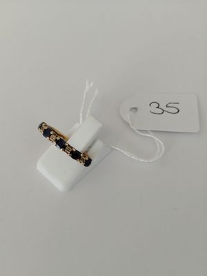 a close up of a ring on a white surface with a price tag