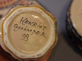 a person holding a small cup with writing on it